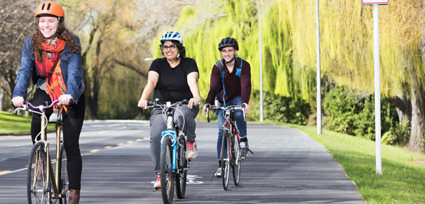 three women riding bikes on cycleway